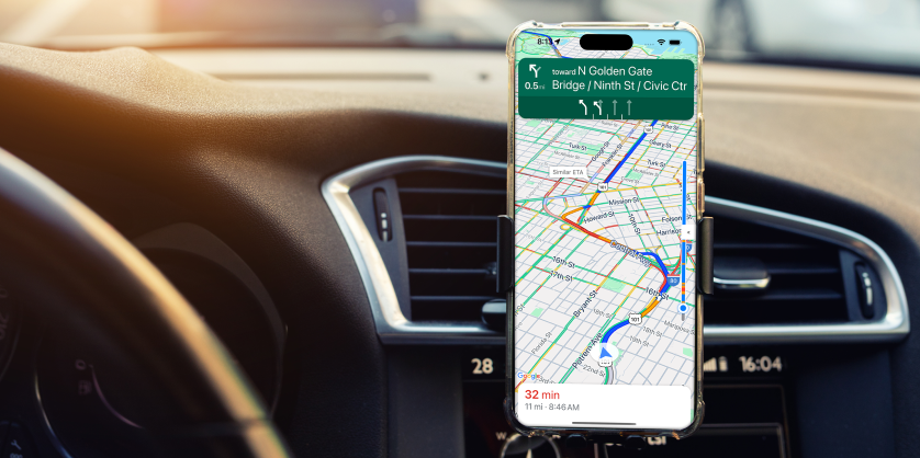 Mobile phone on a dashboard showing Navigation SDK.